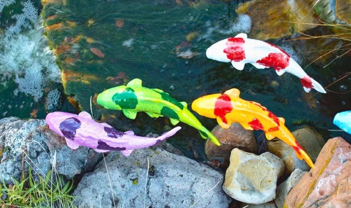 Ceramic koi garden stakes in a pond setting, full colour range
