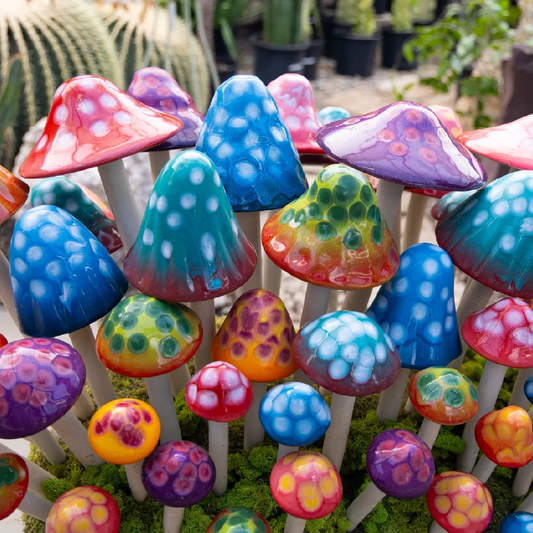 Colorful glass mushrooms on a white background